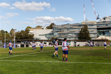 Footscray Rugby Union players in action with the new Pavilion in the background.